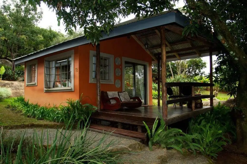 Lidwala Lodge's private chalet with a balcony and beautiful garden view.