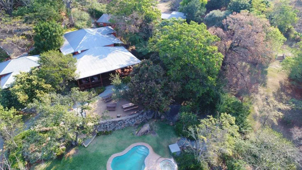 Aerial view of Lidwala Lodge accommodation surrounded by lush nature and majestic mountains - Ideal getaway in Ezulwini Eswatini